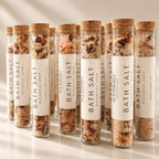 Rows of Etherly bath salt tubes with dried rose petals and cork stoppers