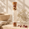 Rose Botanical Mineral Soak in a corked glass tube with dried rose petals